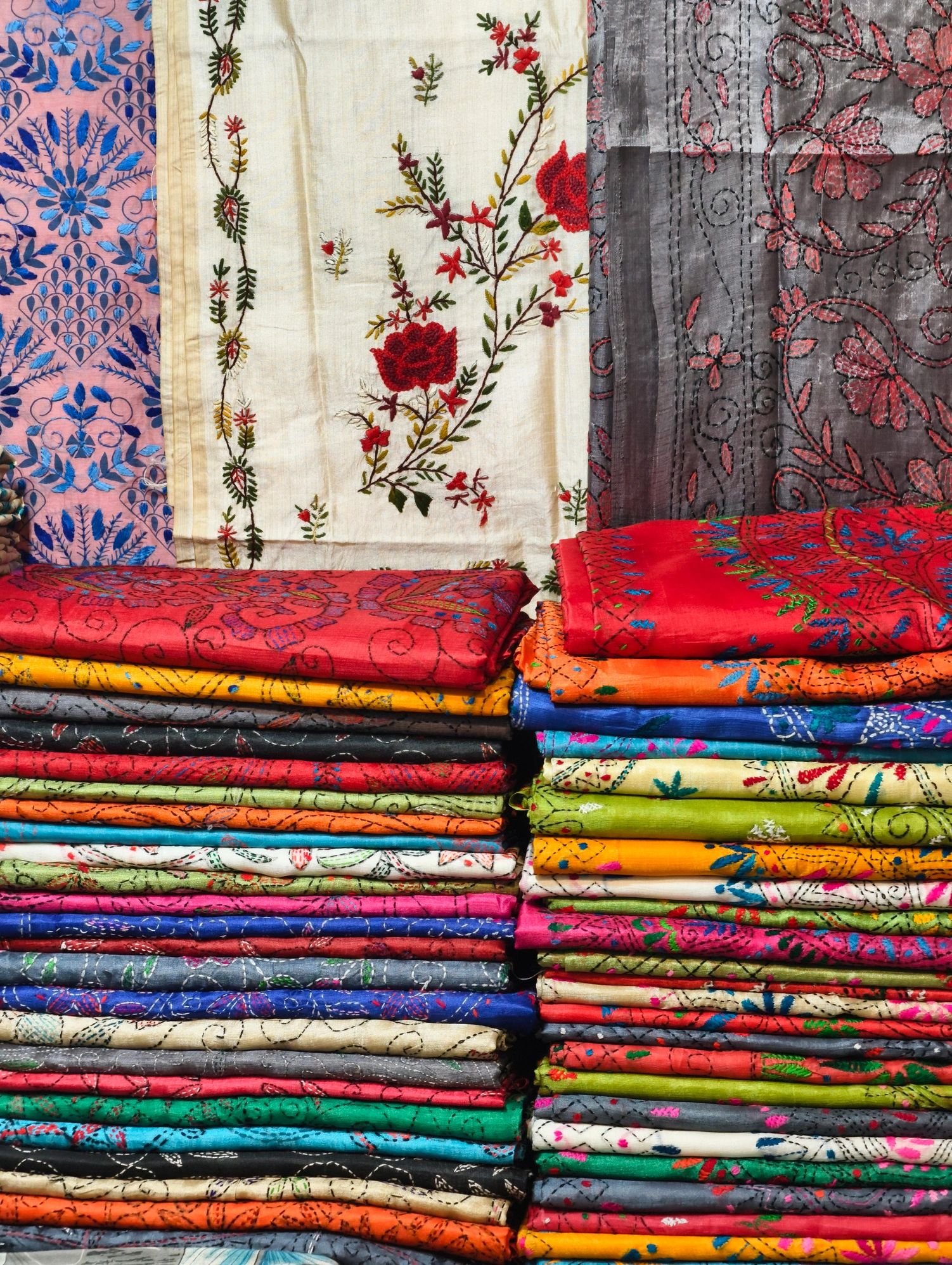 Stacked Indian cotton fabrics in a retail textile display
